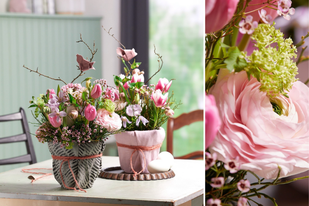 Österliche Frühlingsfloristik in ummantelten Töpfen mit rosa und pinkfarbenen Blumen